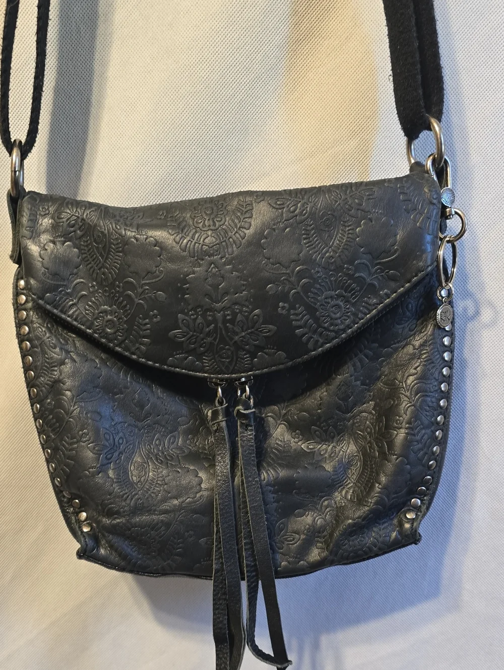 The Sak Black Embossed Leather Crossbody with Tassel Detail